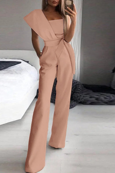 Elegant jumpsuit Chia in pink with asymmetric cut and one sleeve, featuring long and wide pants.